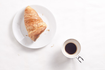 Coffee cup and croissant.