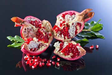 broken ripe pomegranate with leaves