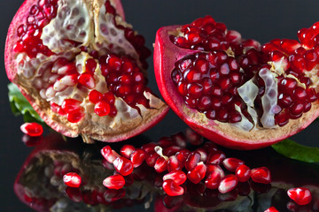 broken ripe pomegranate with leaves