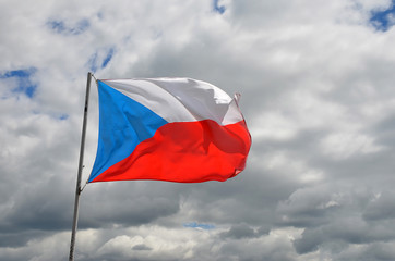 czech republic national flag waving in the wind in summer cloudy sky