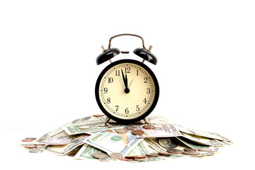 Time is money concept with close up of an old clock on dollar bills