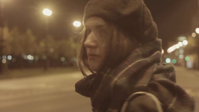 Young woman waiting taxi night city street hyperlapse warm tone shot