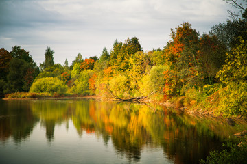 Beautiful autumn landscape with colorful trees at the river