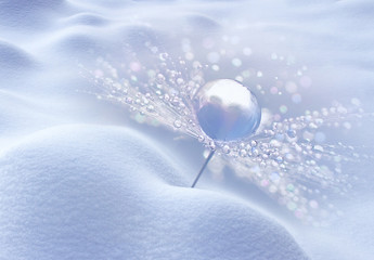 Snowflake of dew drops on a parachutes dandelion in snowdrift in the winter, Abstract artistic image, beautiful soft light blue background . Seed dandelion with drops of dew in a silver color, macro. 