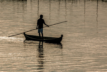 Fisherman on boat in Myanmar