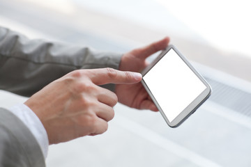 Businessman holding smart phone with empty screen
