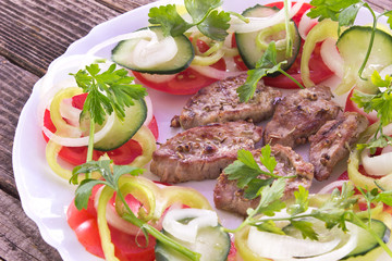 Grilled pork fillet meat and vegetables in plate