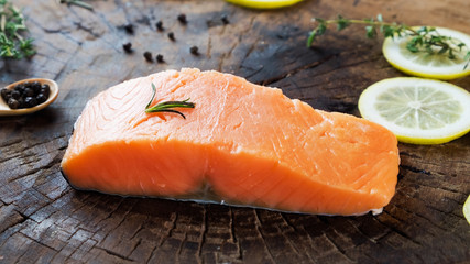 raw salmon with lemon herb black pepper prepare for cook on wooden background 