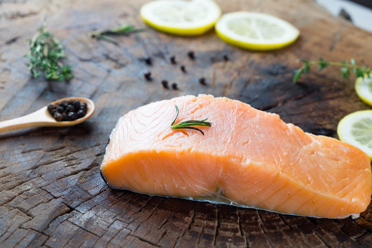 raw salmon with lemon herb black pepper prepare for cook on wooden background 