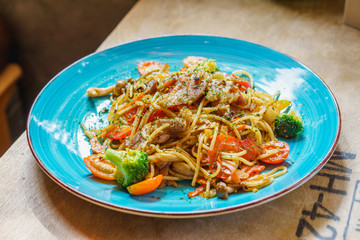 Spaghetti on blue dish with high key.