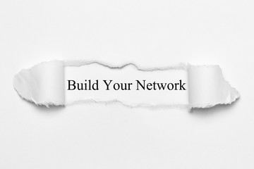 Build Your Network on white torn paper