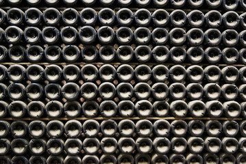 Bottles of sparkling wine in a cellar are put at each other.