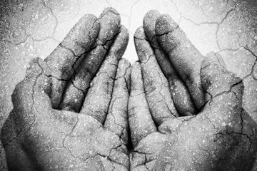 Double exposure hunger begging hands and dry soil