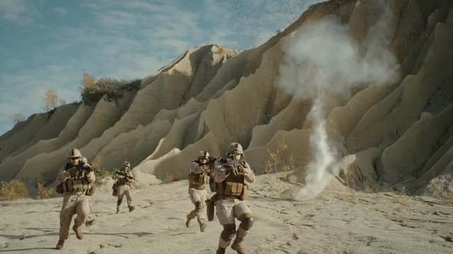  Squad of Fully Equipped, Armed Soldiers Running and Attacking During Battle in the Desert. Shot on RED EPIC Cinema Camera in 4K (UHD).