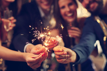 Group of friends having fun with sparklers - obrazy, fototapety, plakaty