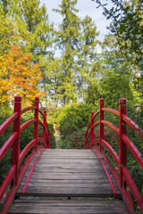 Red pedestrian bridge in Botanical Garden of Cluj, Transylvania, Romania