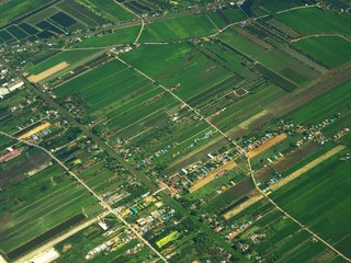 Aerial view of clouds and village landscape. View from aircraft window.