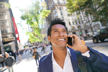 Businessman using smartphone in Manhattan city centre