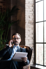 Serious smart businessman working in his study