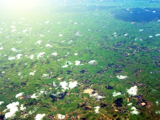 Aerial view of clouds and village landscape. View from aircraft window. © Thitinat.K