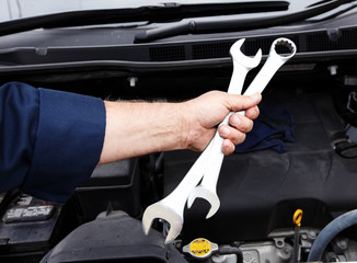 Car mechanic with wrench.