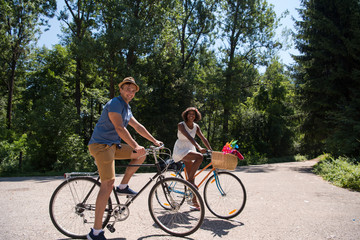 Young multiethnic couple having a bike ride in nature