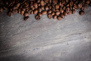 Coffee beans on grunge stone background