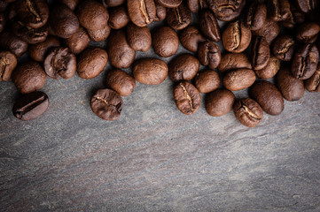 Coffee beans on grunge stone background
