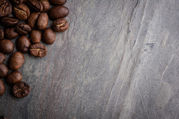 Coffee beans on grunge stone background