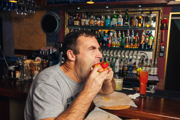 Young man eating a hamburger