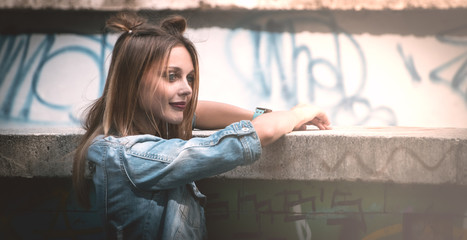 young girl with red lips posing in a denim jacket