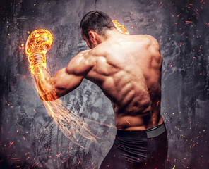 Shirtless aggressive fighter with burning boxer gloves.
