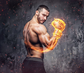 Shirtless aggressive fighter with burning boxer gloves.