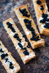 Black caviar on a toast with butter