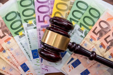 Law gavel with euro on wooden desk