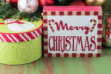 Christmas greeting card with gift box, christmas balls, fir.