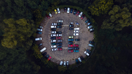 Car parking lot viewed from above, Aerial view. Top view. Parking in the woods in the form of a...