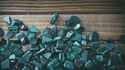 Malachite on wooden background, small shells on a wooden backgro