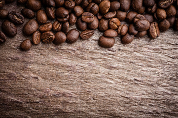 Coffee beans on grunge stone background