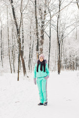Fototapeta na wymiar Beautiful young girl in a white winter forest
