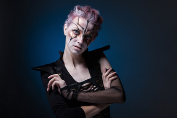 Creative portrait of a girl on a blue background. With colored h