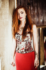Naklejka premium beautiful girl with red hair posing in Studio
