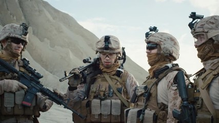 Group of Soldiers are Standing in a Circle and Listening Orders from Commander During Briefing before Military Operation in the Desert. Slow Motion.