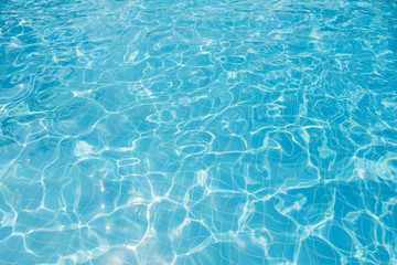 Naklejka na ściany i meble Ripple water in swimming pool witn sun reflection