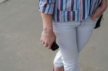 girl walking on the city with her phone