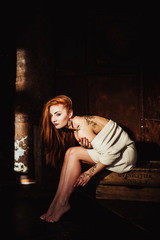 beautiful girl with red hair posing in Studio