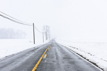 Empty Highway with Yellow Lines in Snow Storm