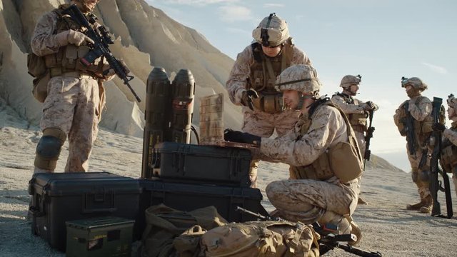 Soldiers are Using Laptop Computer for Surveillance During Military Operation in the Desert. Slow Motion.