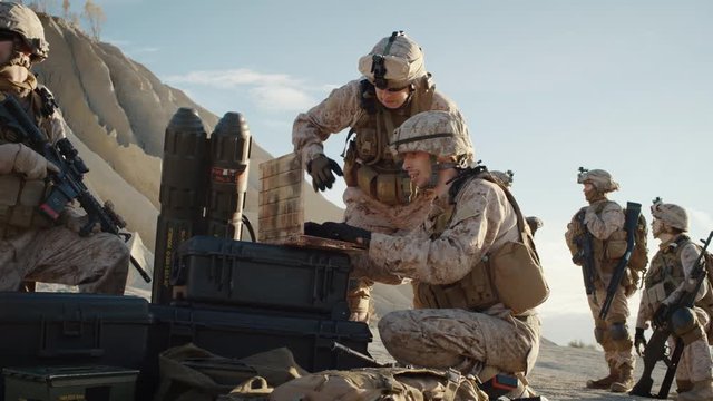 Soldiers are Using Laptop Computer for Surveillance During Military Operation in the Desert. Slow Motion.