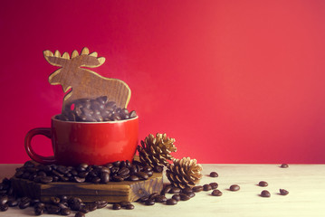 hot cup of coffee and xmas deer and pine cone